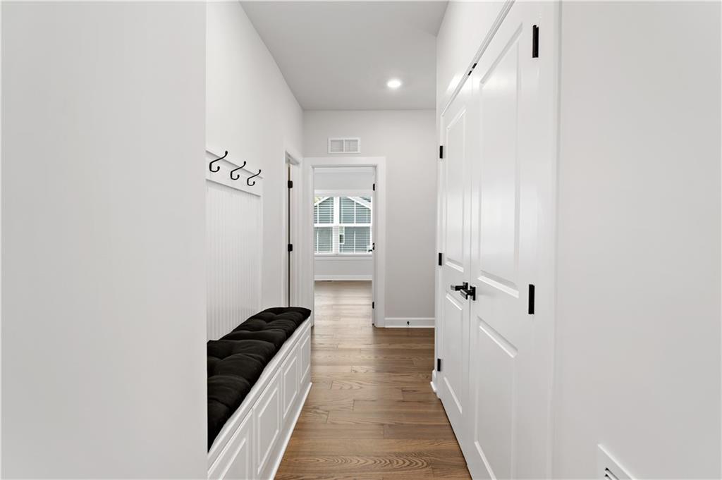 107 Abigail Drive Mars, PA 16046 - Photo 19 of 50 a hallway with white cabinets and black appliances
