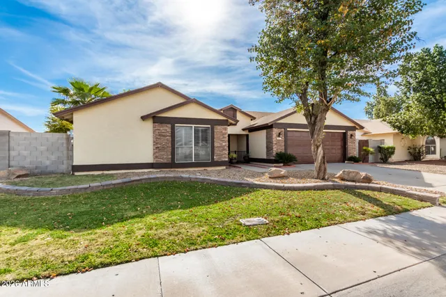 a front view of house with yard and swimming pool