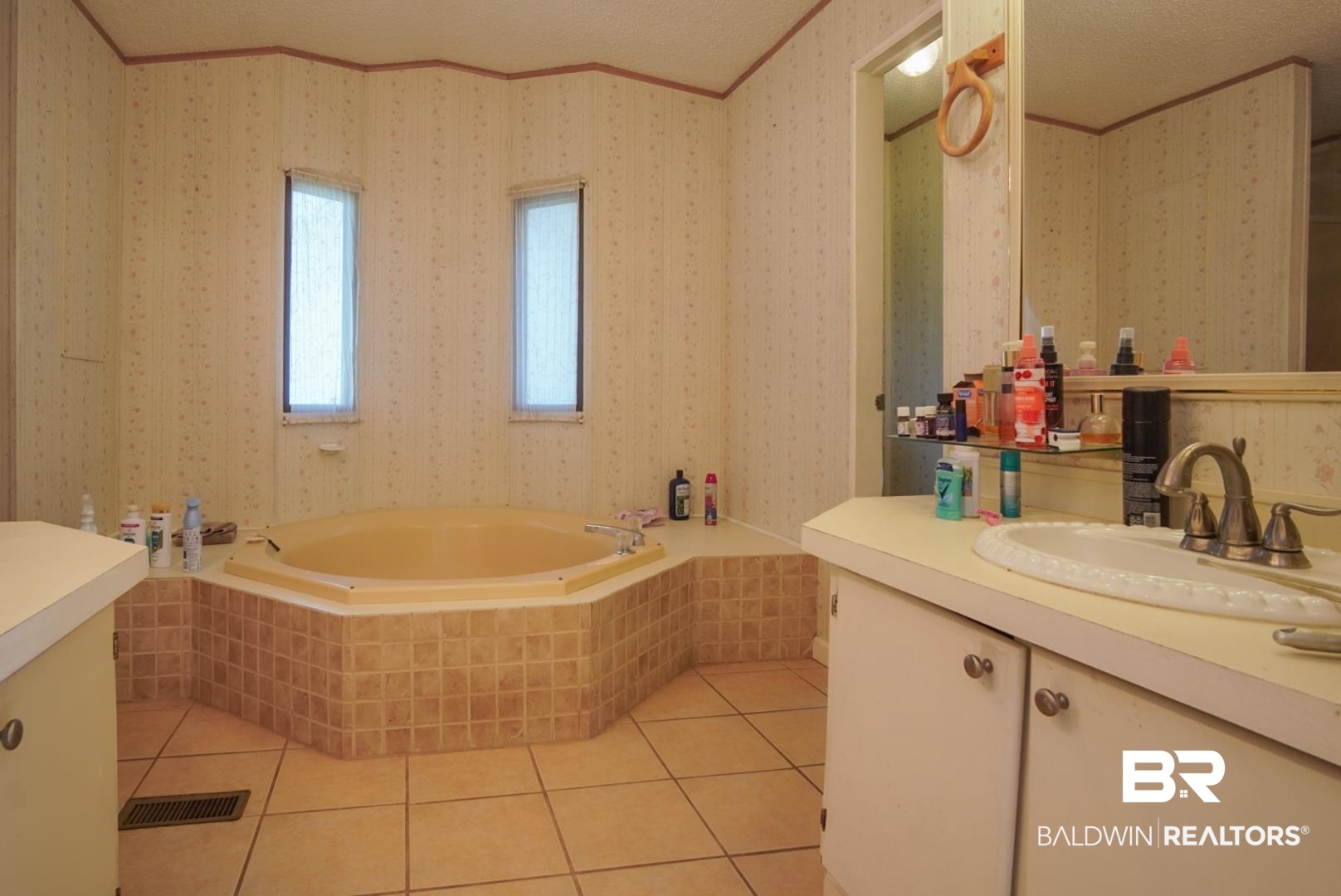 9190 County Road 97 Elberta, AL 36530 - Photo 29 of 53 Bathroom featuring vanity, tiled tub, tile patterned flooring, and a textured ceiling