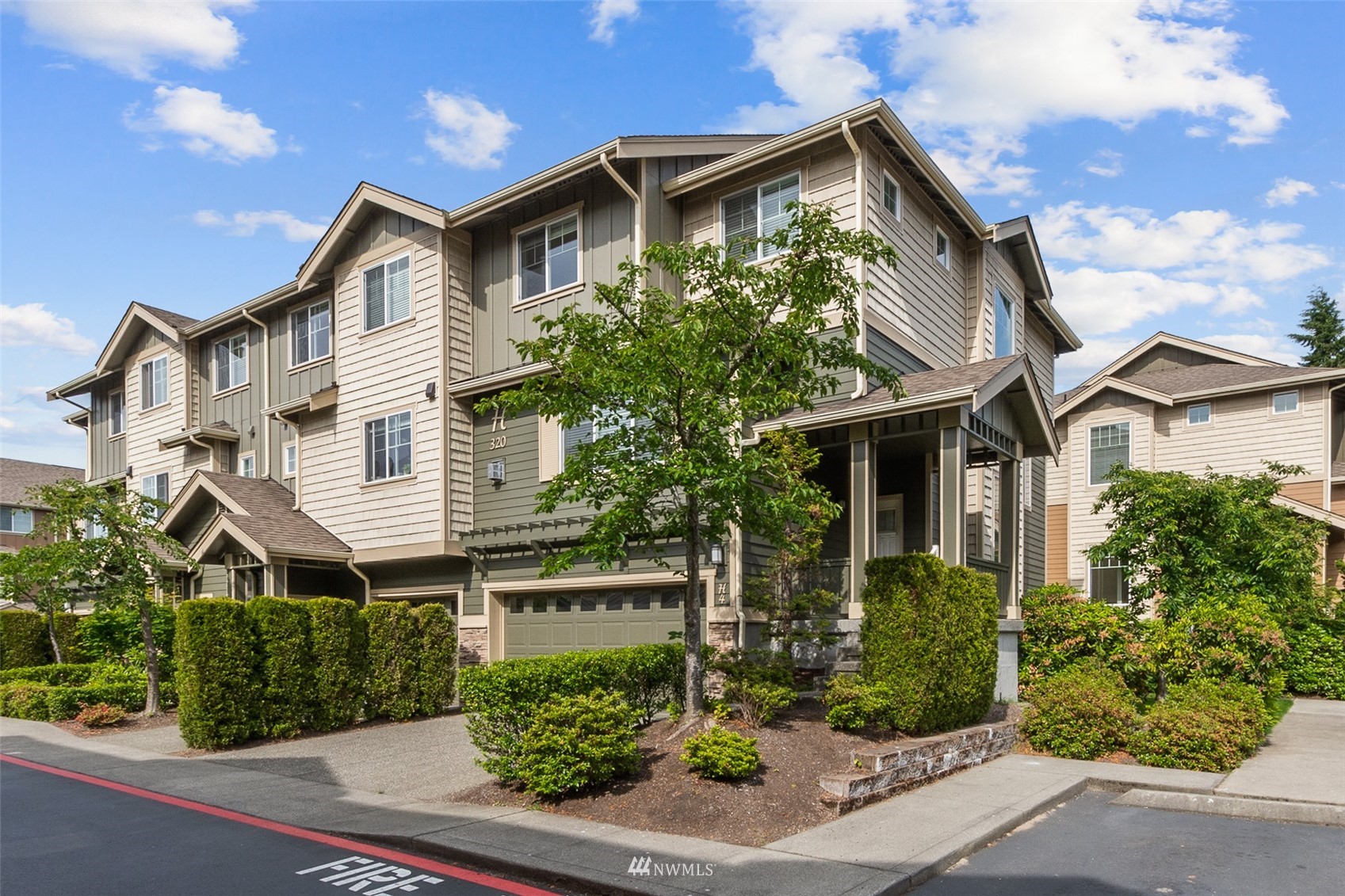 320 Chelan Place Northeast, Unit H4 Renton, WA 98059 - Photo 1 of 25 a front view of a house with garden