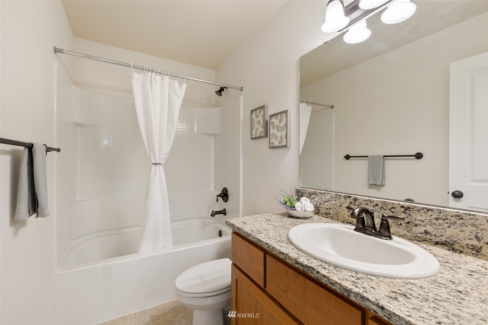 320 Chelan Place Northeast, Unit H4 Renton, WA 98059 - Photo 16 of 25 a bathroom with a granite countertop sink toilet and shower
