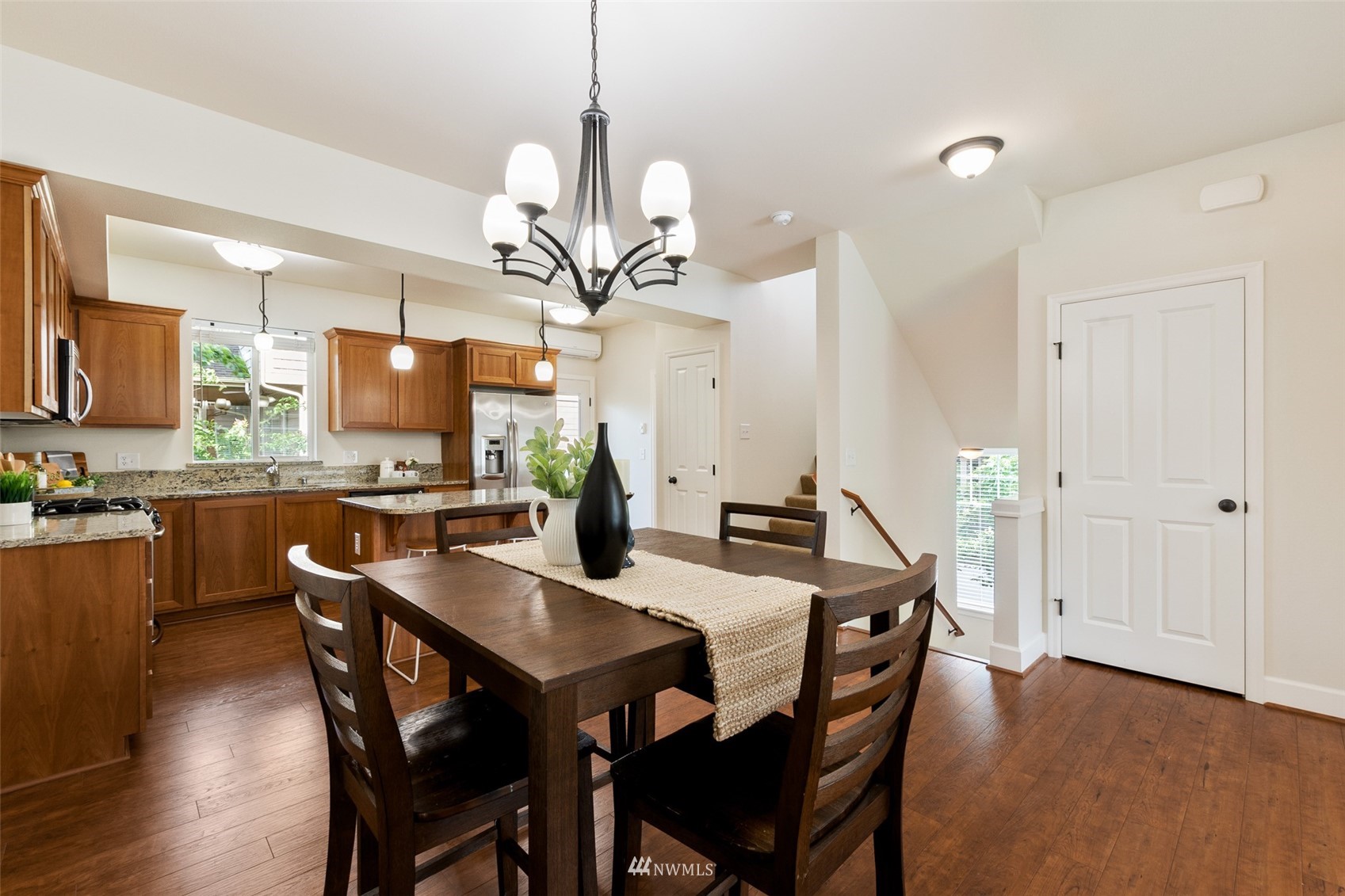 320 Chelan Place Northeast, Unit H4 Renton, WA 98059 - Photo 8 of 25 a view of a dining room and a kitchen with a table chairs