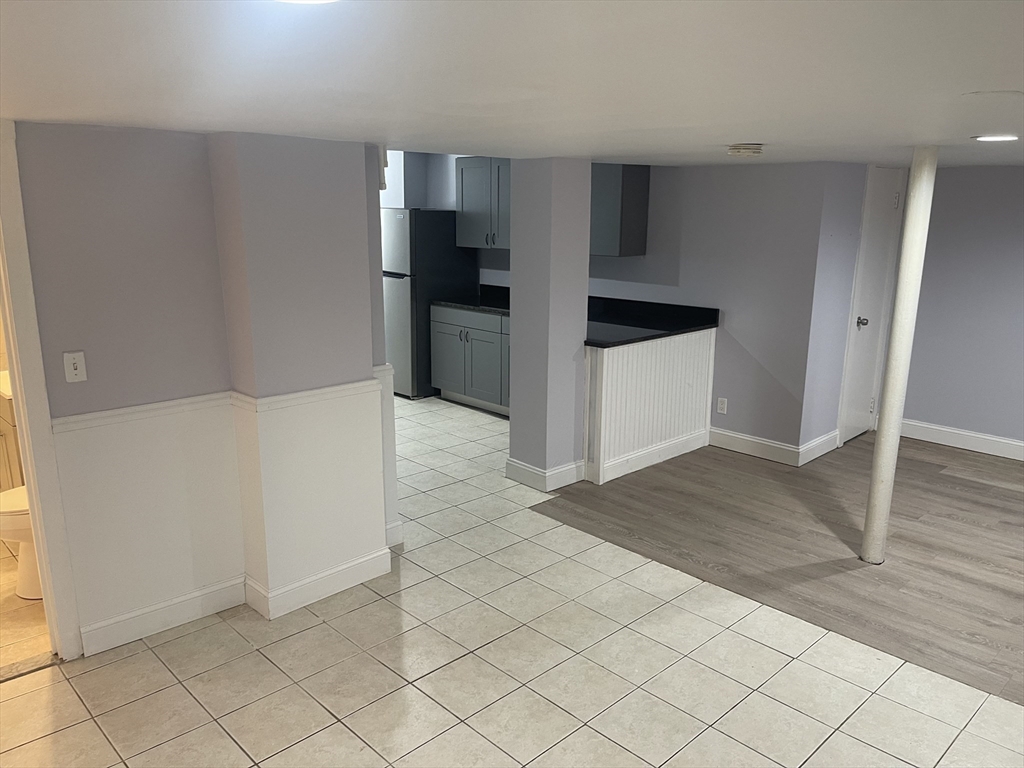 23 Spring Street, Unit B Malden, MA 02148 - Photo 2 of 9 a kitchen with cabinets and wooden floor