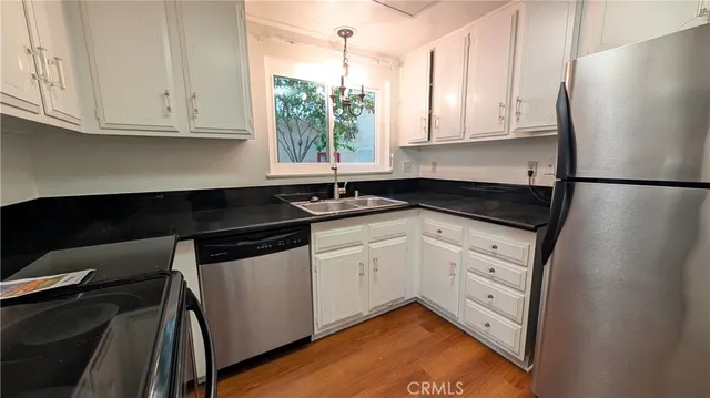 a kitchen with stainless steel appliances granite countertop a sink and cabinets
