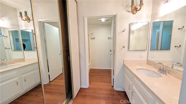 a bathroom with a glass shower door and a sink