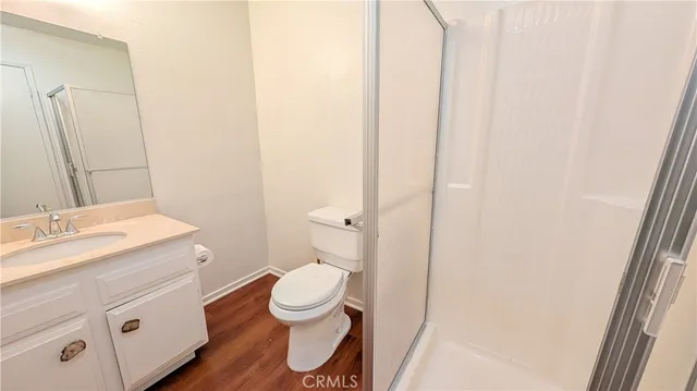 a bathroom with a sink a toilet a mirror and vanity