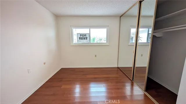 a view of a room with wooden floor and a window