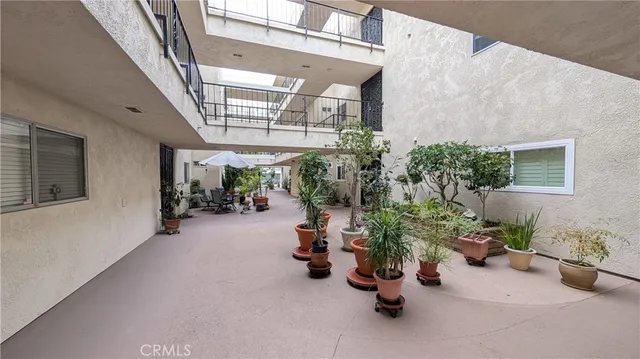 a view of a chairs and table in the patio and a fountain