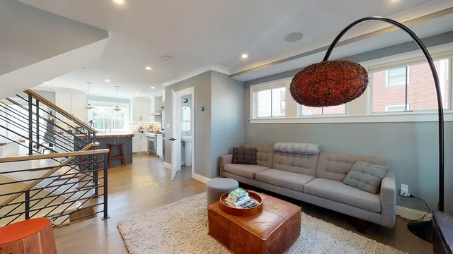 a living room with furniture a glass and a large window