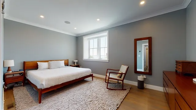 a bedroom with a bed and a couch