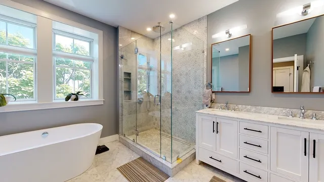 a bathroom with a bathtub sink and mirror