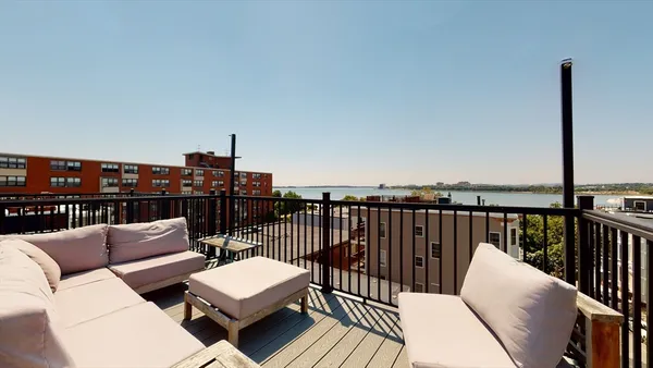 a balcony with wooden floor and furniture