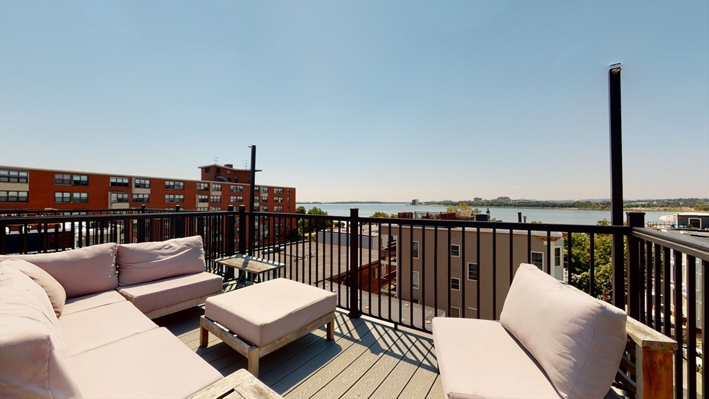 459 East 8th Street, Unit 1 Boston, MA 02127 - Photo 26 of 31 a balcony with wooden floor and furniture