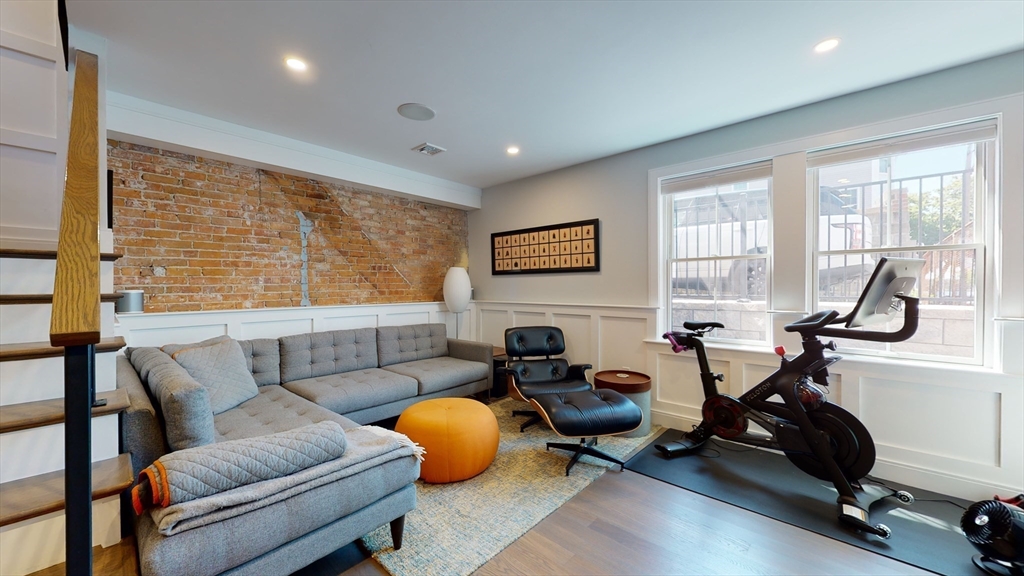 459 East 8th Street, Unit 1 Boston, MA 02127 - Photo 28 of 31 a living room with furniture a window and gym equipment