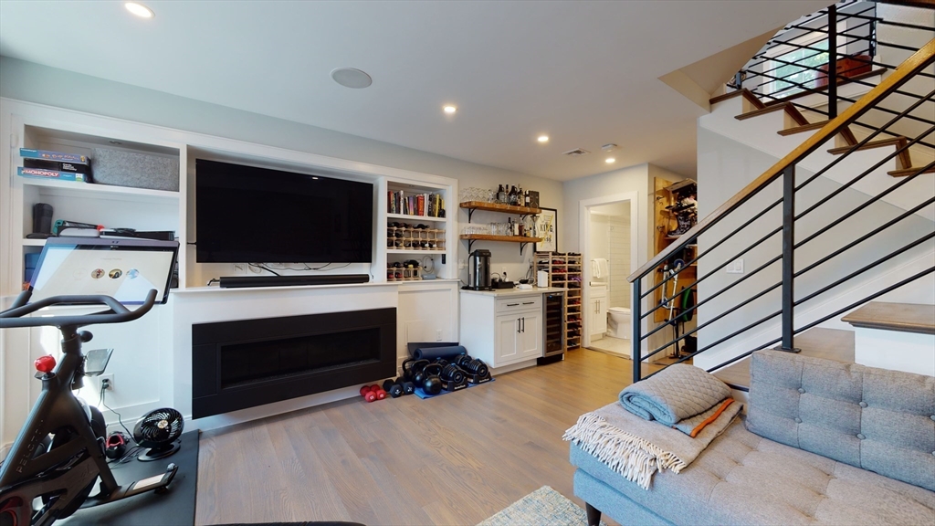 459 East 8th Street, Unit 1 Boston, MA 02127 - Photo 29 of 31 a living room with furniture a flat screen tv and a fireplace