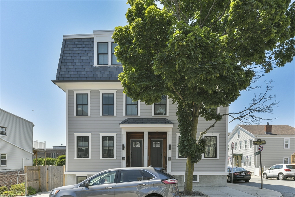 459 East 8th Street, Unit 1 Boston, MA 02127 - Photo 30 of 31 a front view of a residential apartment building with a yard