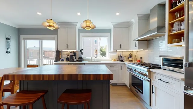 a kitchen with a sink appliances and cabinets