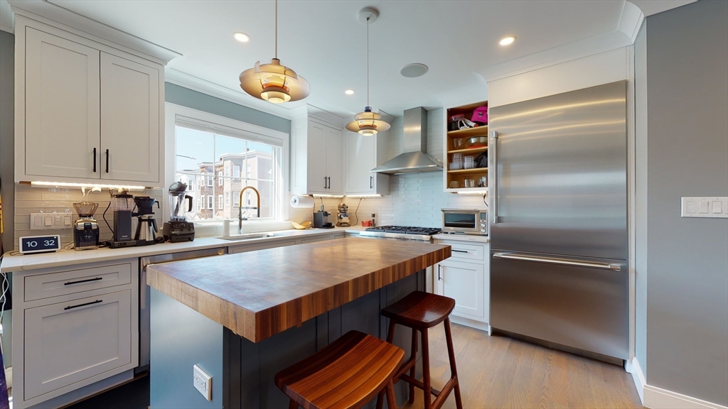 459 East 8th Street, Unit 1 Boston, MA 02127 - Photo 5 of 31 a kitchen with a refrigerator a sink and cabinets