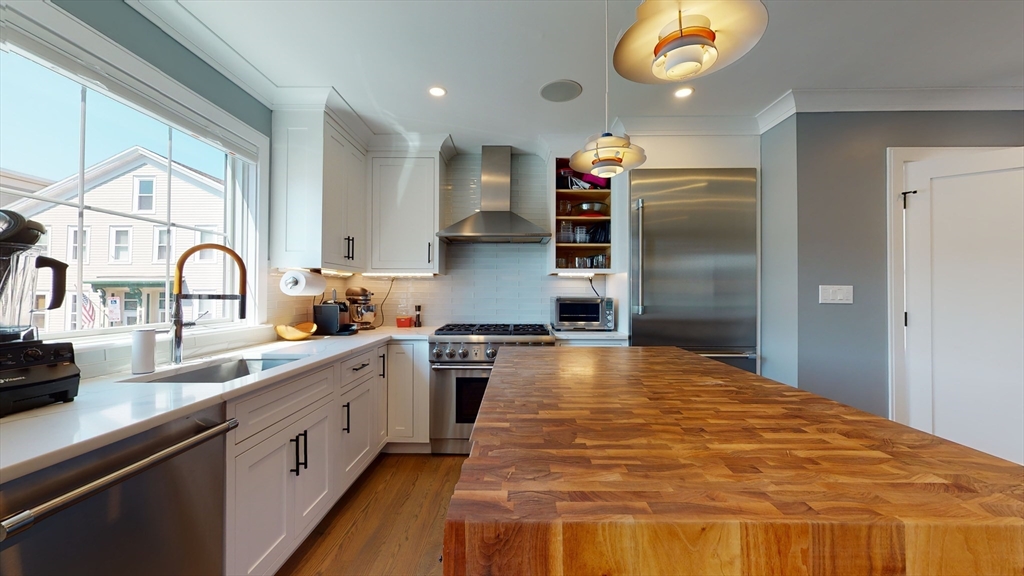 459 East 8th Street, Unit 1 Boston, MA 02127 - Photo 8 of 31 a kitchen with stainless steel appliances a sink stove and refrigerator