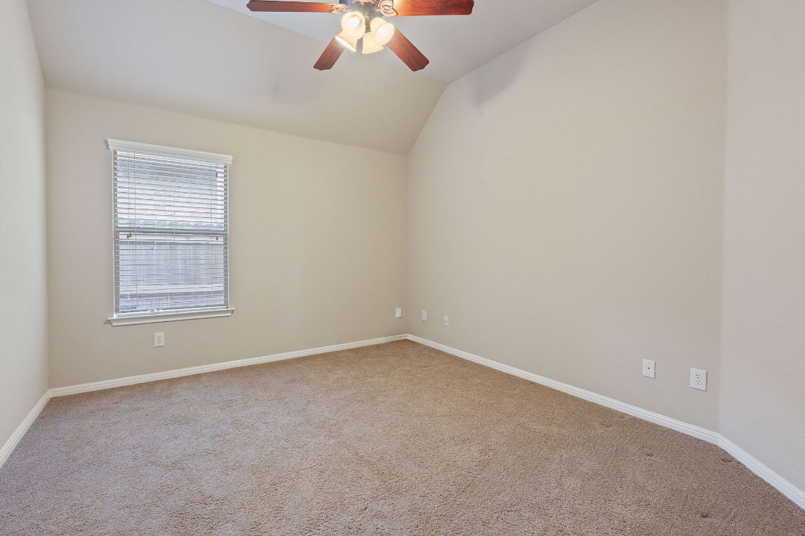 1809 Cross Draw Trail Leander, TX 78641 - Photo 17 of 22 an empty room with a chandelier fan