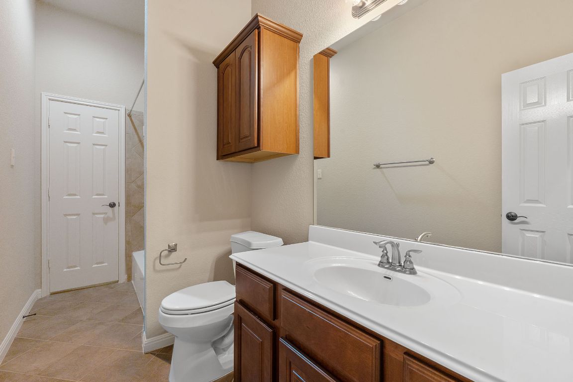 1809 Cross Draw Trail Leander, TX 78641 - Photo 20 of 22 a bathroom with a sink a toilet and mirror