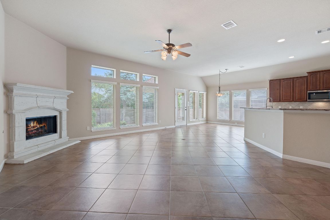 1809 Cross Draw Trail Leander, TX 78641 - Photo 3 of 22 a view of an empty room with a fireplace and a window