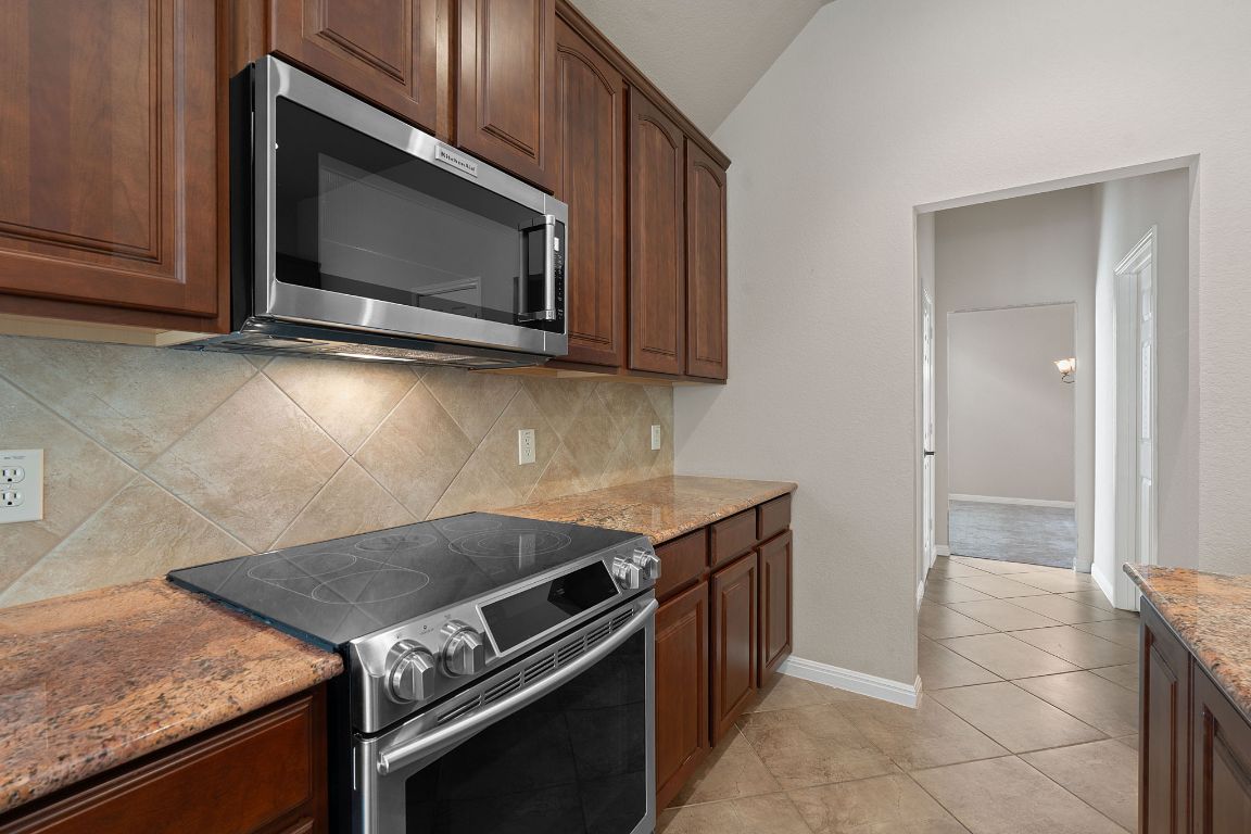 1809 Cross Draw Trail Leander, TX 78641 - Photo 7 of 22 a kitchen with a stove and a microwave