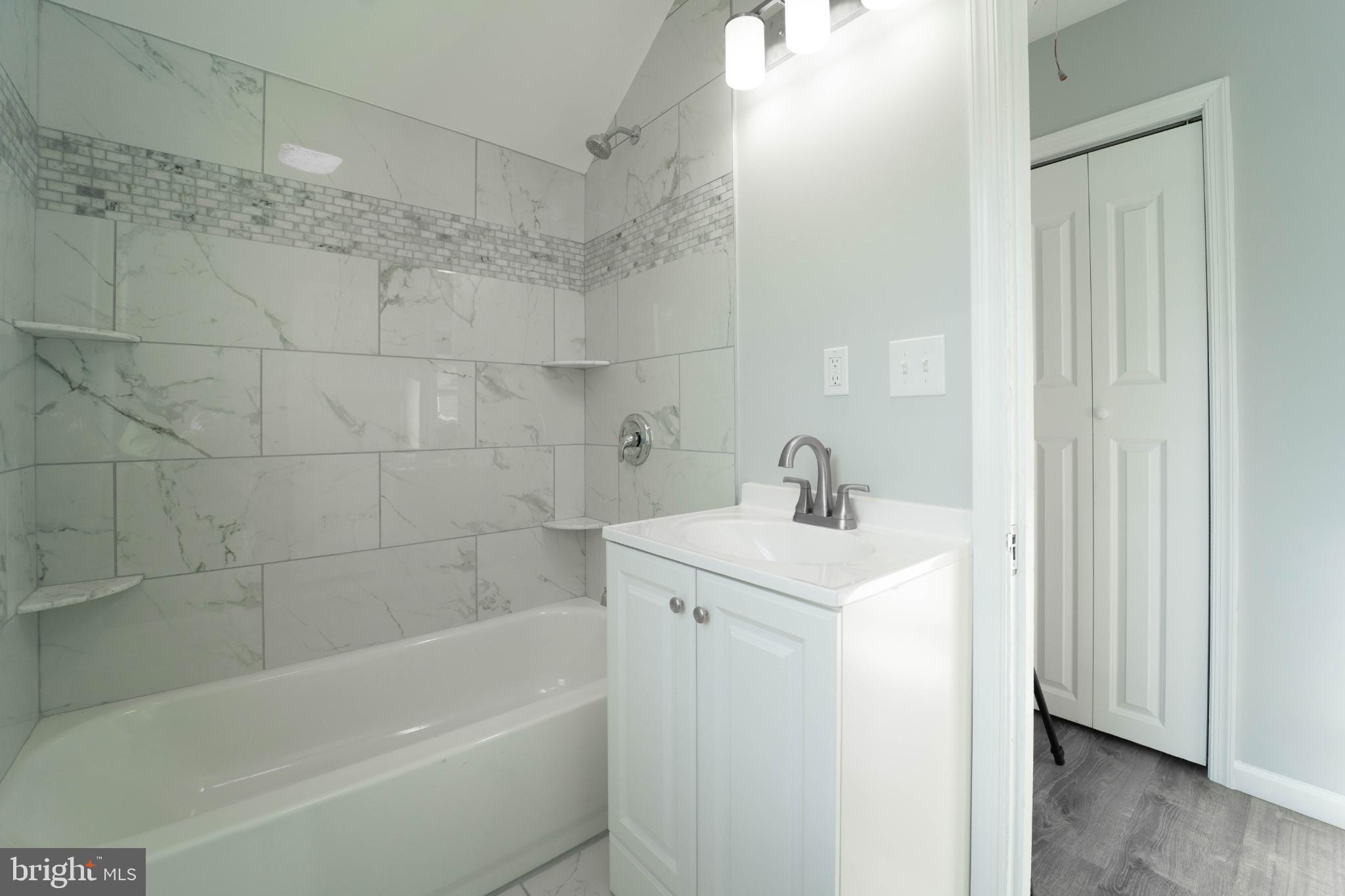 5312 Catalpha Road Baltimore, MD 21214 - Photo 31 of 59 a white bath tub sitting next to a white sink