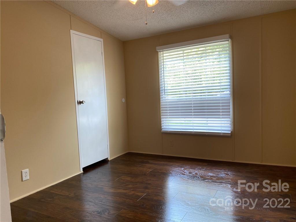 3283 Rhyner Road Lancaster, SC 29720 - Photo 29 of 35 a view of an empty room with wooden floor and a window
