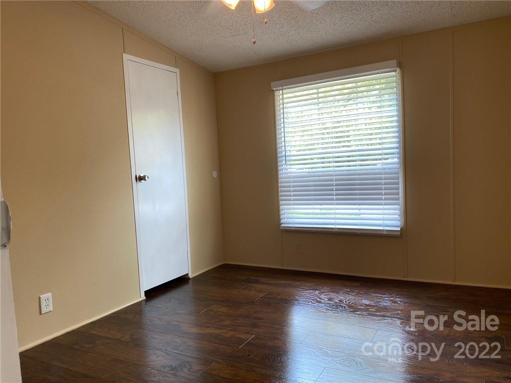 3283 Rhyner Road Lancaster, SC 29720 - Photo 31 of 35 a view of an empty room with wooden floor and a window