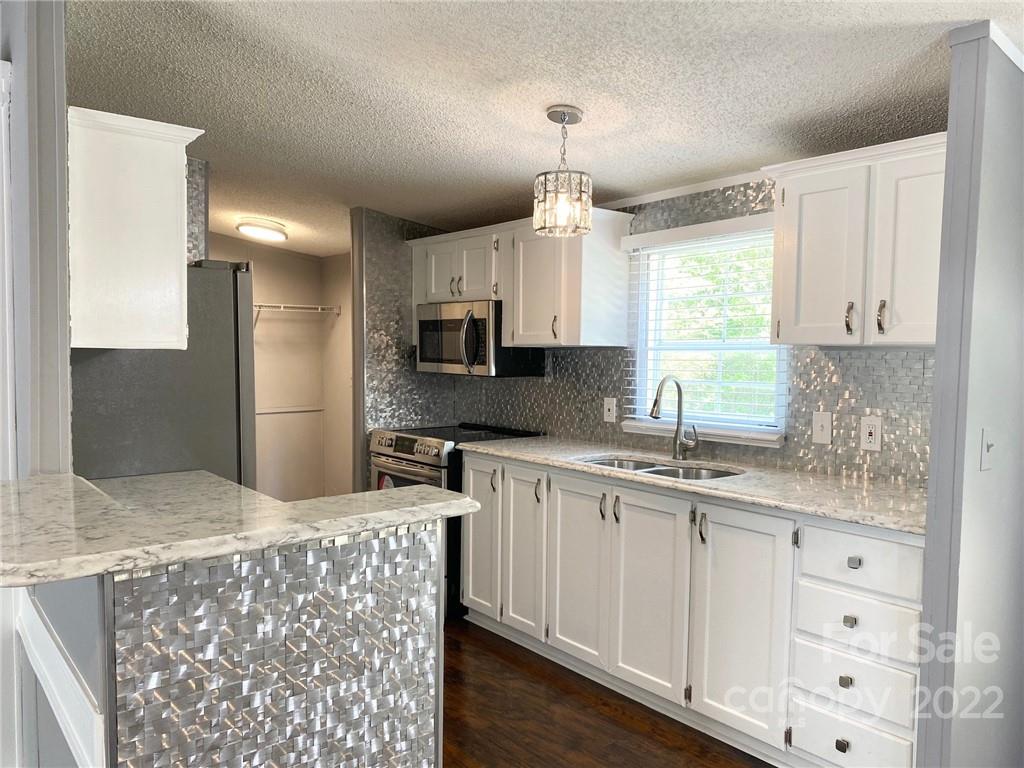 3283 Rhyner Road Lancaster, SC 29720 - Photo 9 of 35 a kitchen with stainless steel appliances a sink stove and refrigerator