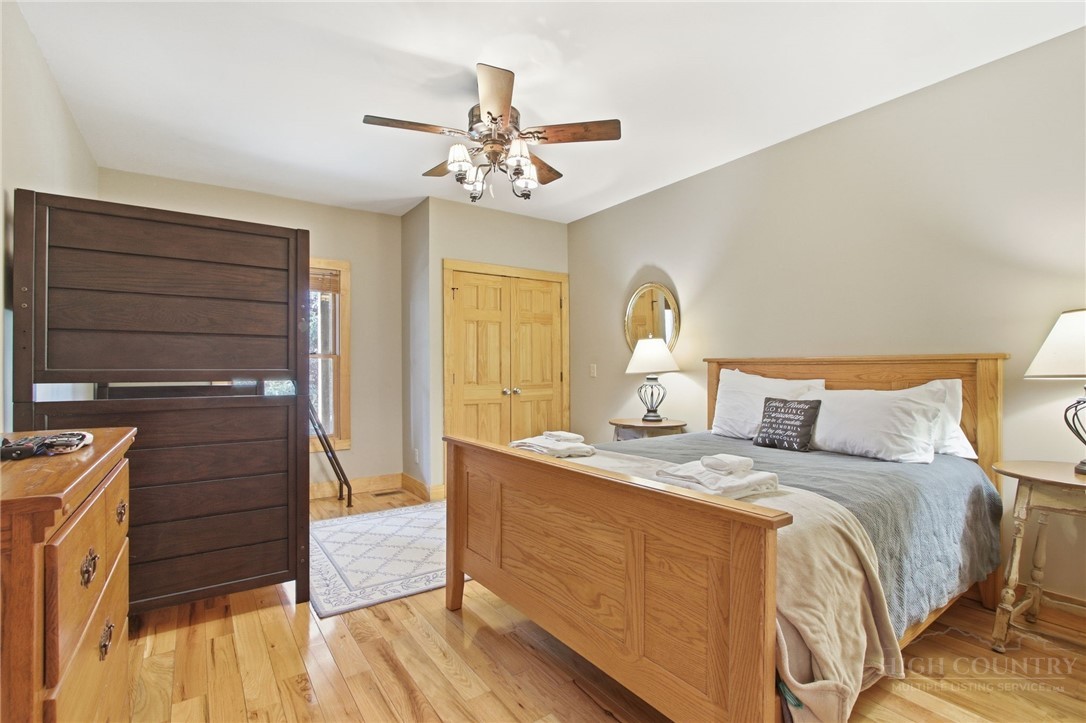 2081 Blackberry Road Boone, NC 28607 - Photo 42 of 45 a bedroom with a bed and wooden floor