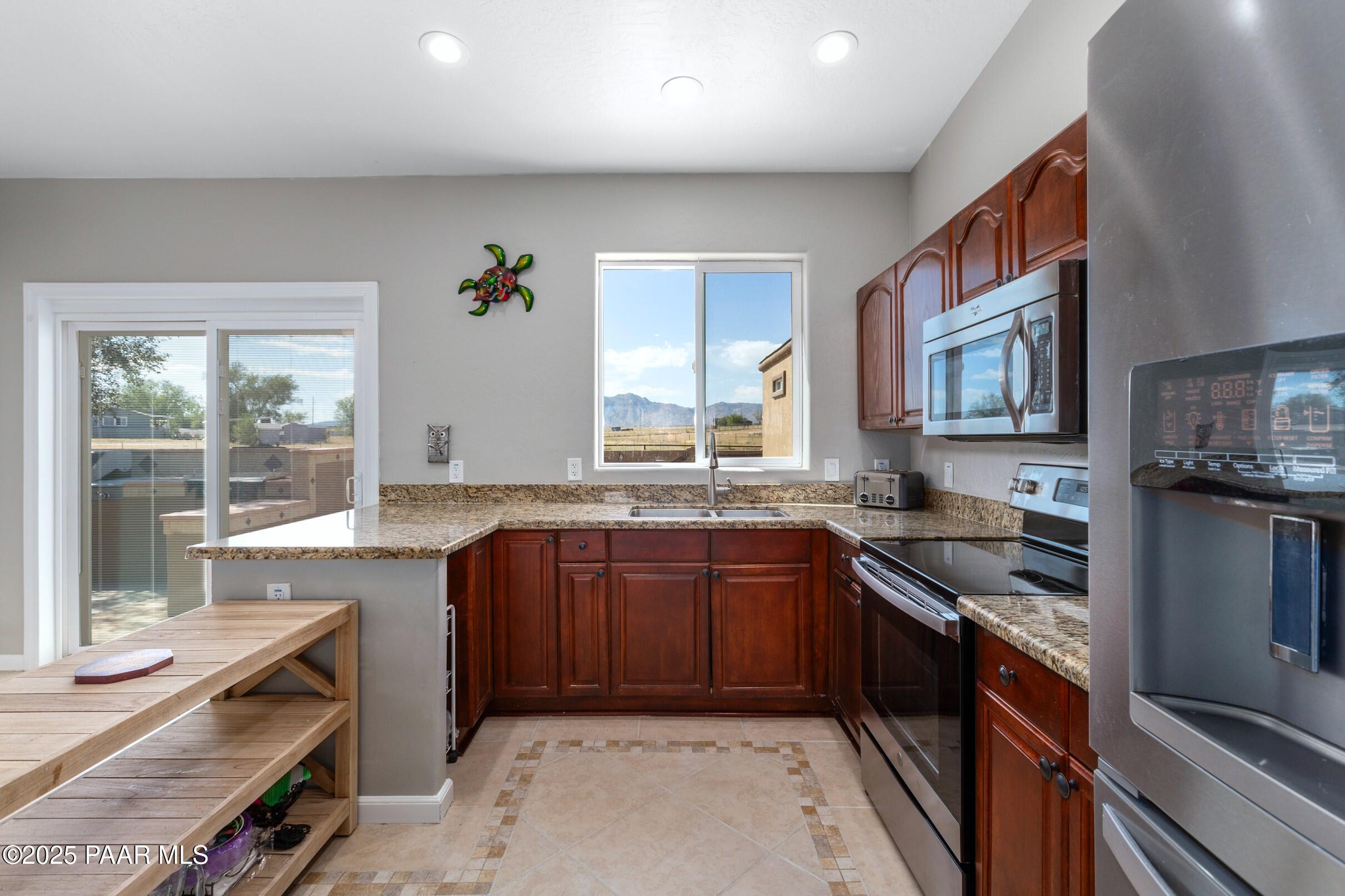 1780 South Yellow Brick Road Chino Valley, AZ 86323 - Photo 20 of 47 a kitchen with stainless steel appliances granite countertop a sink stove and refrigerator