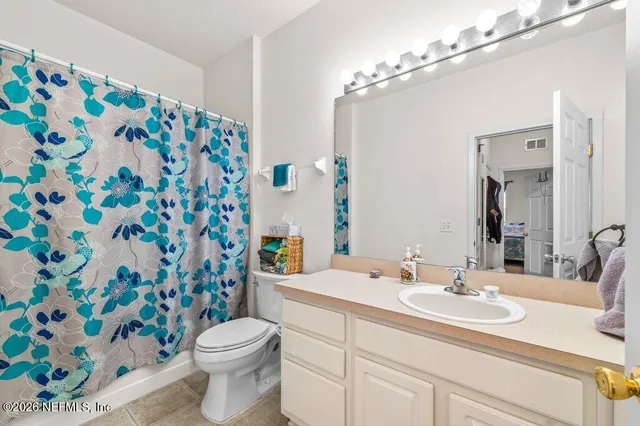 a bedroom with furniture and a flat screen tv