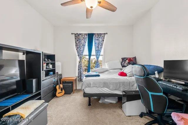 a view of walk in closet with clothes