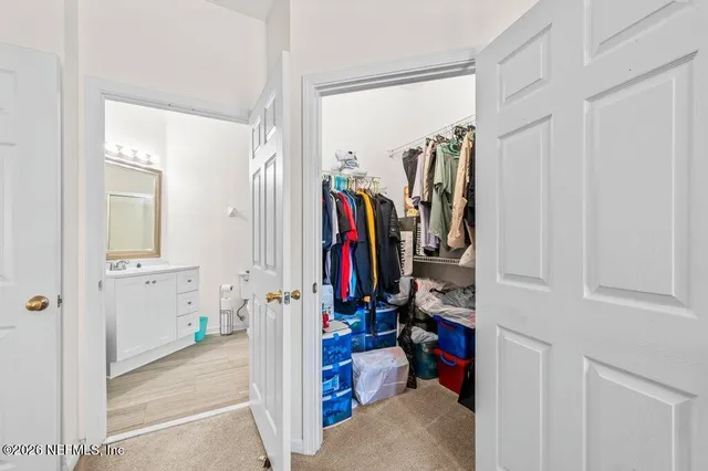a bathroom with a toilet sink and a mirror