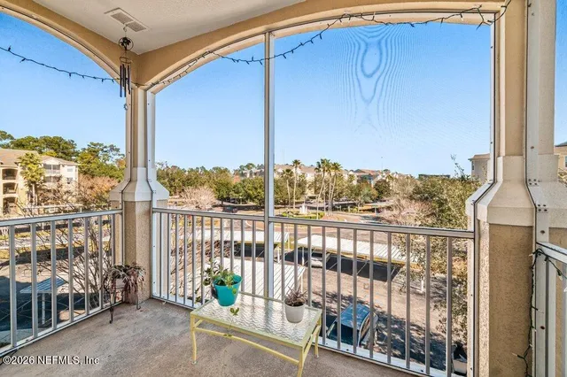 an aerial view of a house with swimming pool and outdoor seating