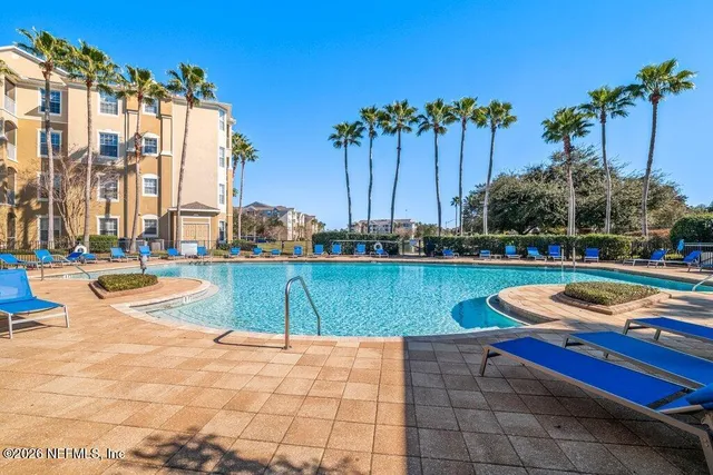 a view of a park with multi story residential apartment building in the back