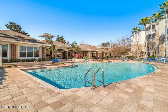 a view of a dining room with furniture wooden floor and chandelier