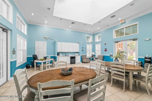 a view of a terrace with a table and chairs under an umbrella