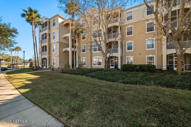 a view of a building with a yard