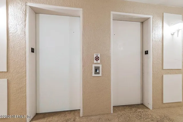 a view of a hallway with a door
