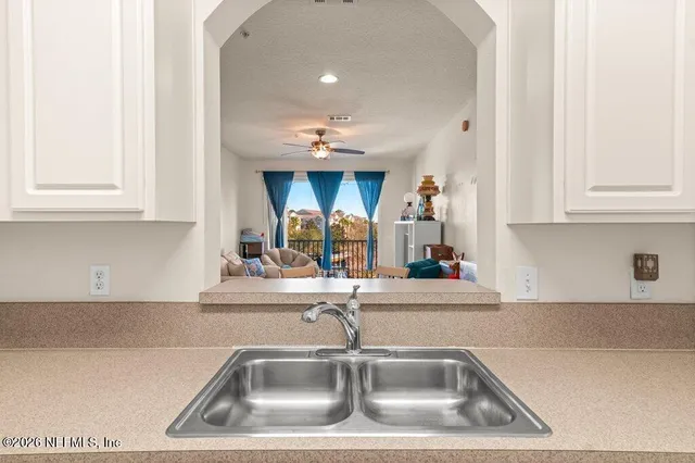 a kitchen with kitchen island a sink and chandelier