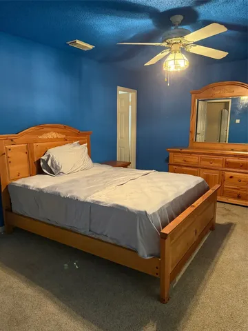 a bedroom with a bed and a mirror