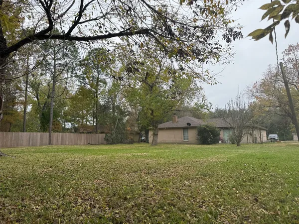 a big yard with lots of green space and trees