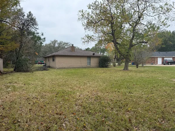 a front view of house with yard and trees
