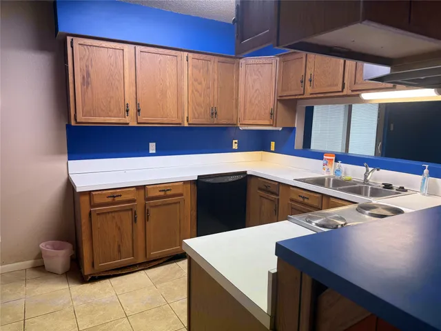 a kitchen with a sink cabinets and white appliances