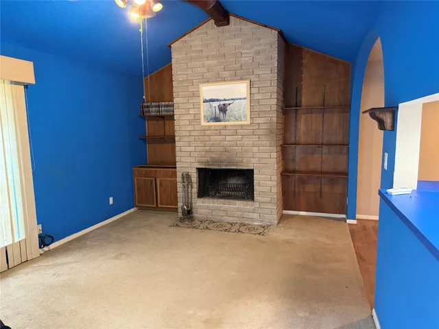 a view of an empty room with a fireplace