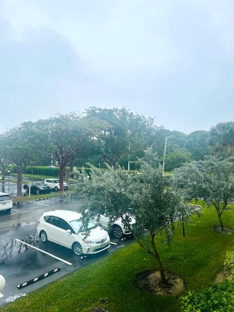 951 De Soto Road, Unit 233 Boca Raton, FL 33432 - Photo 15 of 41 a view of a garden with lawn chairs