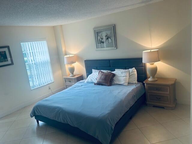 951 De Soto Road, Unit 233 Boca Raton, FL 33432 - Photo 16 of 41 a bedroom with bed and window